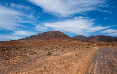 Fototapeta na wymiar The beautiful volcanic landscape of the Las Talahijas with road on the island of Fuerteventura. Canary Islands. Spain. October 2019