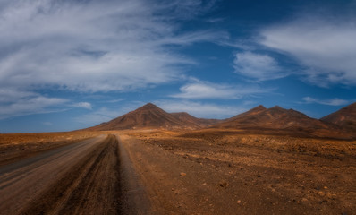 The beautiful volcanic landscape of the Las Talahijas with road on the island of Fuerteventura. Canary Islands. Spain. October 2019