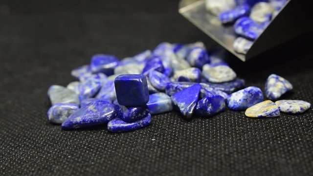 Lapis Is a beautiful natural gemstone on a wooden floor	