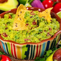 Avocado Guacamole Mexican Dip with Avocado, Lime, Tomato and Cilantro. Selective focus.