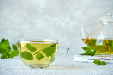 Fresh natural melissa , lemon balm herbal tea in glass cup.	