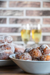 Two types of sugar donuts and sima. Traditional labour day sweets.
