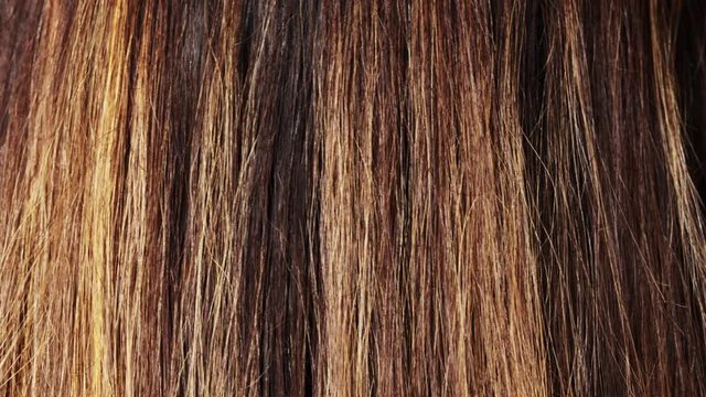 Long brunette hair with highlights close-up, young woman with straight shiny dyed hair, colored layers, care concept, 4k