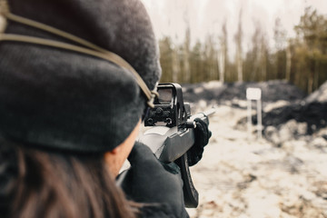 A guy shoots from a hunting rifle on the shooting range in the desert sport shooting