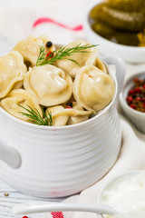 Beef and Pork Dumplings - Russian and Ukrainian Meat Pelmeni on Wooden Background. Selective focus.