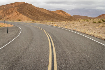 A curving road enters Death Valley from the Nevada side.