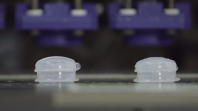 plastic bottles on Medical Solutions Conveyor . Blow fill seal technology technique used to produce liquid-filled container on medical or food industrial factory. close up medical industry