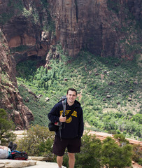 Guy posing at the the angels landing viewpoint in Zion national park, Utah, USA