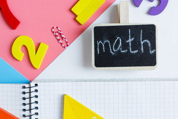 Colorful math fractions, notebook on blue pink white background. Interesting, fun mathematics for kids. Education, back to school concept	