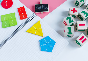 Colorful math fractions, notebook on blue pink white background. Interesting, fun mathematics for kids. Education, back to school concept	