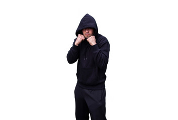 Young Caucasian Adult Man wearing black sweat pants and hoody is standing in a Fighting Stance.. Isolated on White Background. Perfect for image composite