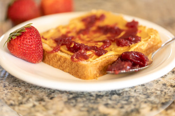 Peanut butter toast with strawberry jam