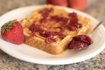 Peanut butter toast with strawberry jam