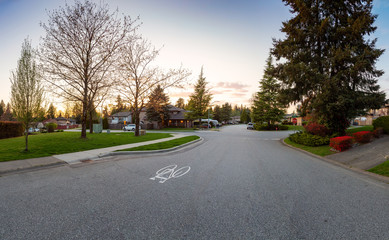 Residential Suburban Neighborhood in the City during a vibrant springtime sunset. Taken in Fraser Heights, Surrey, Vancouver, BC, Canada. Panorama, Wide Angle