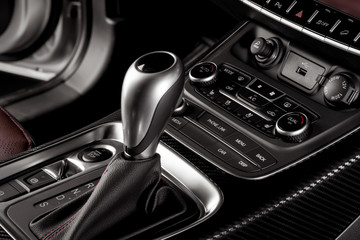 Electronic Gear Shift close up inside a new car with start stop button and electronic hand brake