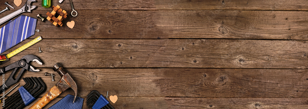 Poster fathers day theme corner border of gifts, tie and tools on a rustic wood banner background. top view