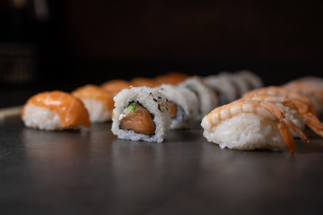 Fresh salmon sushi , salmon maki roll Japanese food restaurant, salmon sushi on plate. Sushi platter with a mixed variety of the Japanese delicacy at a buffet spread table.