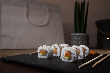 Fresh salmon sushi , salmon maki roll Japanese food restaurant, salmon sushi on plate. Sushi platter with a mixed variety of the Japanese delicacy at a buffet spread table.