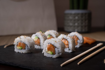 Fresh salmon sushi , salmon maki roll Japanese food restaurant, salmon sushi on plate. Sushi platter with a mixed variety of the Japanese delicacy at a buffet spread table.