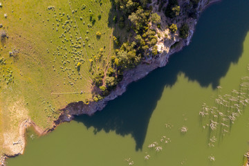 Aerial drone top-down shot of a river and cliff 
