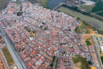 Fototapeta premium Aerial drone shot of a beautiful town in spain with river flowing 
