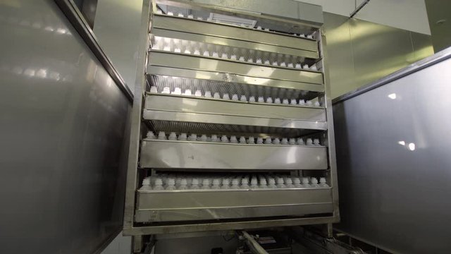 plastic bottles on sterilizer of Medical Solutions Conveyor, . Blow fill seal technology technique used to produce liquid-filled container on medical or food industrial factory. medical industry