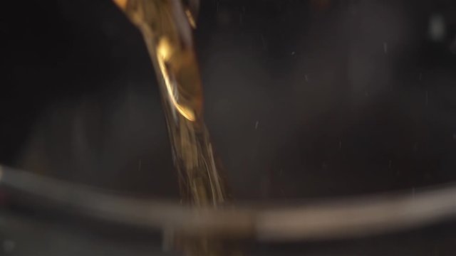 Super extreme close up pouring coca cola soft drink soda in a glass.