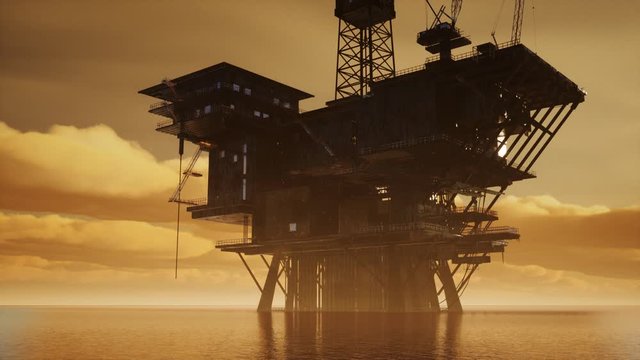 Offshore Jack Up Rig in The Middle of The Sea at Sunset Time
