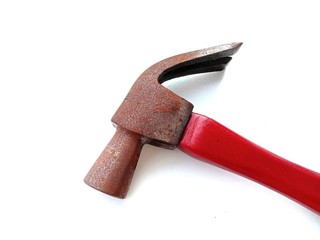 Rusty metal hammer head red wooden handle hardware tools isolated on white background closeup. In Samut Sakhon, Thailand.