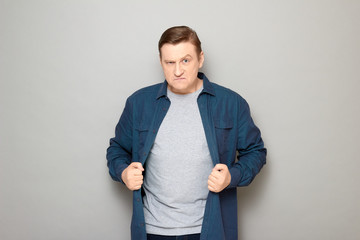 Portrait of furious annoyed blond mature man with angry expression