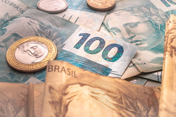 Brazilian Real - BRL, money from Brazil. Real banknotes and coins in close-up photo. Concepts of...