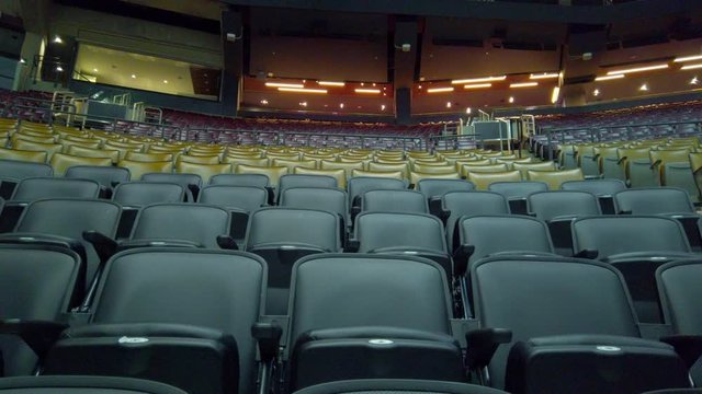 Seats at empty sports concert arena - wide tracking shot