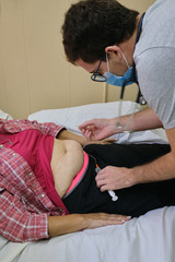 a physician doing a subcutaneous vial for the treatment of an adult woman with covid-19 during the pandemic
