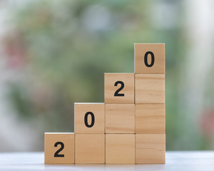 Year 2020 concept with stacked wooden cube
