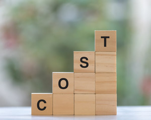Cost concept with stacked wooden cube