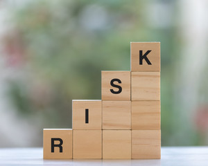 Risk concept with stacked wooden cube