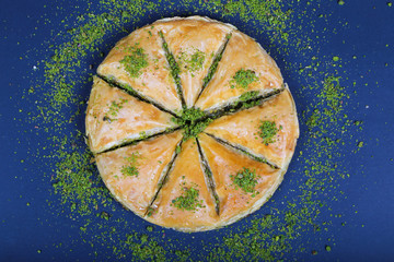 circle Baklava slices Turkish ramadan Dessert with blue background