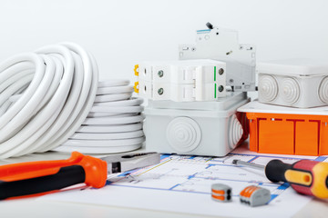 Different electrical equipment and tool on light background. Repair of electrical system at house.