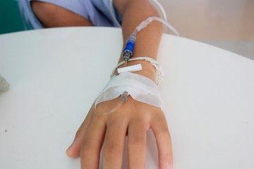 Close up child hand saline intravenous. Baby admitted at hospital. Health care and Medical equipment concept.