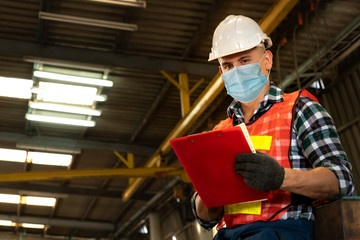 Factory workers with face mask protect from outbreak of Coronavirus Disease 2019 or COVID-19....