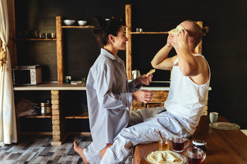 Beautiful young couple cooking in kitchen at home
