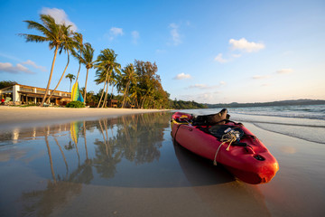 Fototapeta premium Red kayaks are at the beach by the sea in the evening at Ko Kood, Thailand, in the summer holiday concept.