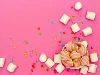 sweet marshmallows on a pink background, the concept of a holiday and congratulations, birthday and children's holiday
