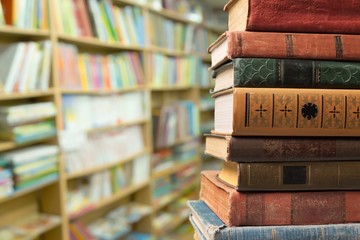 Collection of old books stack on library background