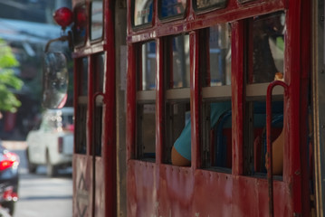 Fototapeta na wymiar Beautiful red retro style bus window and her passenger