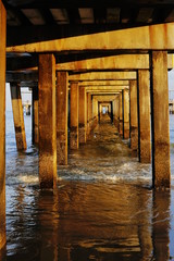 wooden pier in sunset and beach old bridge sea
