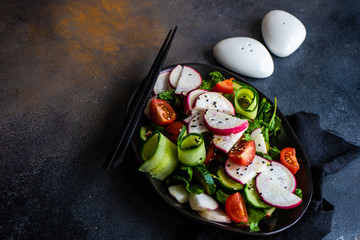 Healthy vegetable salad on rustic background