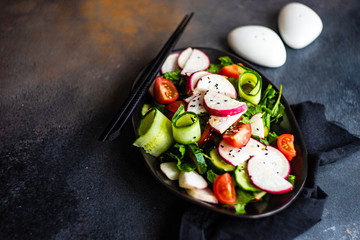 Healthy vegetable salad on rustic background