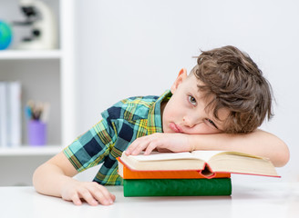 Lazy boy lies on the books at a school