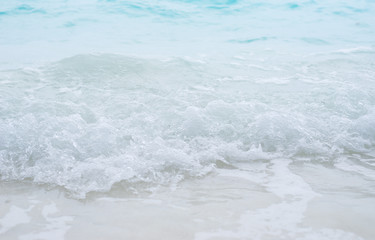 Sea waves splashing on the white beach